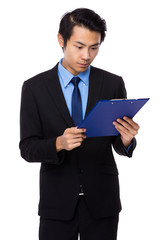 Businessman read on clipboard