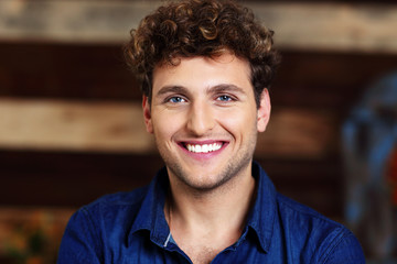 Portrait of a smiling handsome man with curly hair