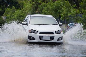 Obraz na płótnie Canvas Splash by a car as it goes through flood water