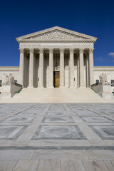 Supreme courthouse in Washington, blue sky behind.