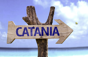 Catania wooden sign with a beach on background