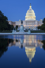 The Capitol building in Washington D,C illuminated at night.