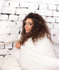 Obraz premium young woman under duvet