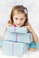 Beautiful little girl with christmas presents