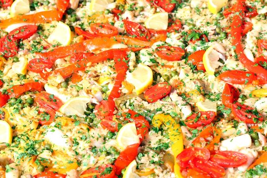 Valencian paella with seafood and tomato peppers