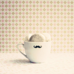 Vintage tea cup with macaroons