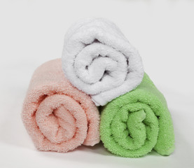 three rolled towels, isolated on white background