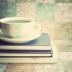 Coffee cup over vintage notebooks
