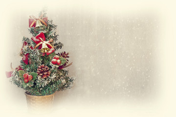 Fototapeta na wymiar small christmas tree with snowfall background and white border