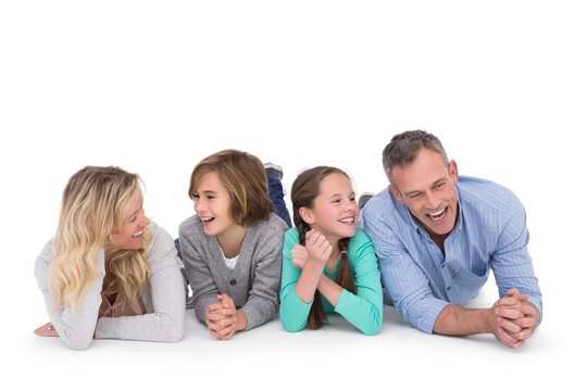 Cute family lying on the floor smiling at camera