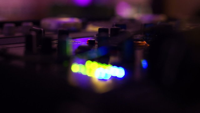 DJ Mixing board with blue and green lights
