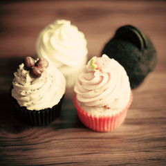 Vintage cupcakes over wood background
