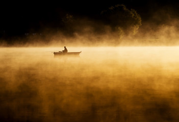 Early morning sunrise, boating on the lake in a huge fog - 71944781