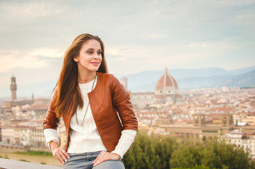 Beautiful girl impressed view the panorama of Florence in autumn