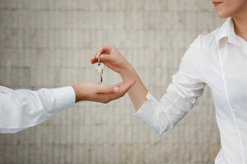 Man and woman hand passing keys