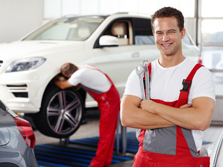 Apprentices for car mechanic is satisfied with his job
