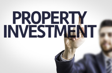 Business man pointing the text: Property Investment