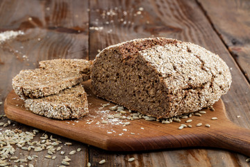 Freshly baked traditional bread on old vintage wooden table