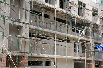 worker on iron scaffolding at construction site