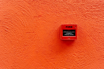 fire alarm switch on the red wall