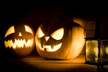 Halloween pumpkins with a lantern on wooden background