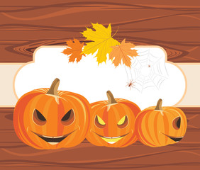 Halloween pumpkins on the wooden background with frame
