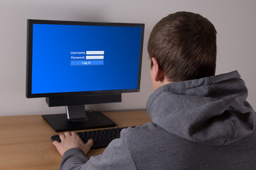 young man typing username and password