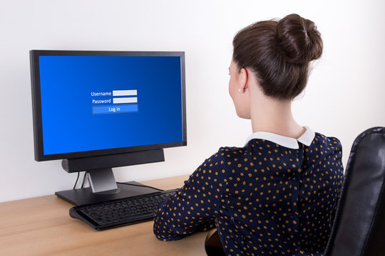young beautiful business woman using pc with login panel on scre