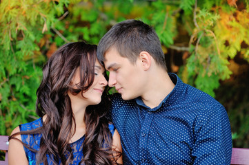 Fototapeta premium young couple in love sitting on the bench, a romantic moment