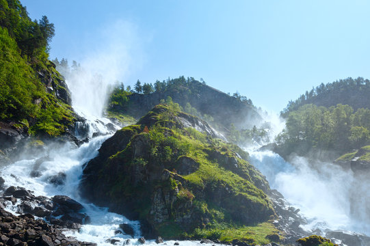 Summer Latefossen waterfall on mountain slope (Norway).