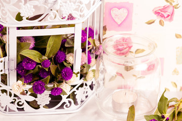Decorative elements- flowers in cage and candle.
