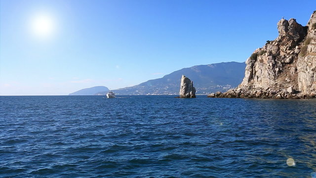 walking ship floats by Parus Rock in Yalta. Crimea