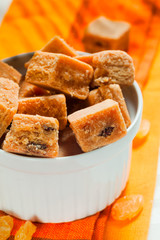 a bowl with milk caramel candies with raisins