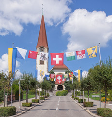 Street, decorated with flags for the Swiss Nationa