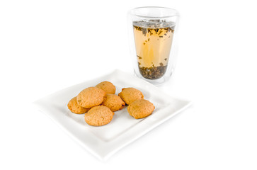 Breakfast composition:  cup, plate,  and  cookies