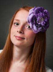 Young girl with flowing red hair on a black background