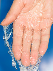 hand in the water on a blue background