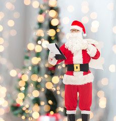 man in costume of santa claus with notepad and bag
