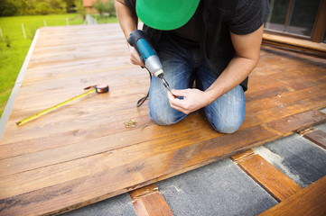 Handyman installing wooden flooring