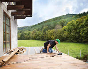 Handyman installing wooden flooring