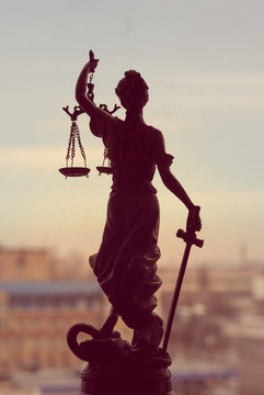 Themis or Lady Justice standing on window