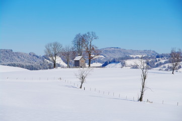 Fototapeta na wymiar Chapel in winter landscape
