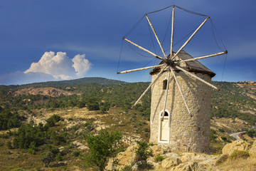Historical old windmill with a dramatic sky background