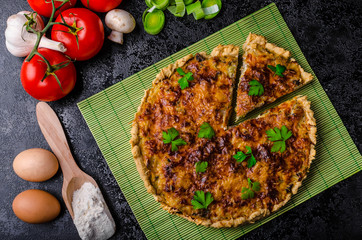 Home French quiche stuffed with mushrooms, tomato and leek
