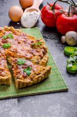 Home French quiche stuffed with mushrooms, tomato and leek