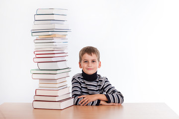 Schoolboy and a heap of books