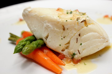 grilled Pangasius fish steak, isolated on a white plate