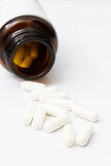 Pills spilling out of pill bottle