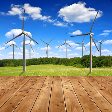 Meadow with wind turbines and wooden planks