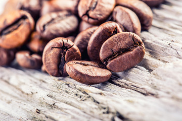 Coffee beans  on grunge wooden background.Macro